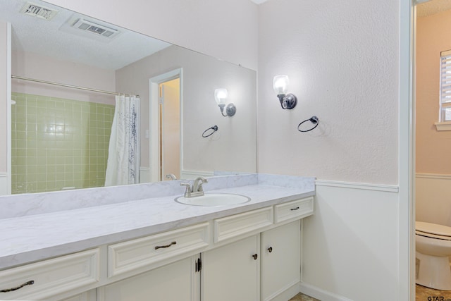 bathroom with vanity, a textured ceiling, toilet, and a shower with shower curtain