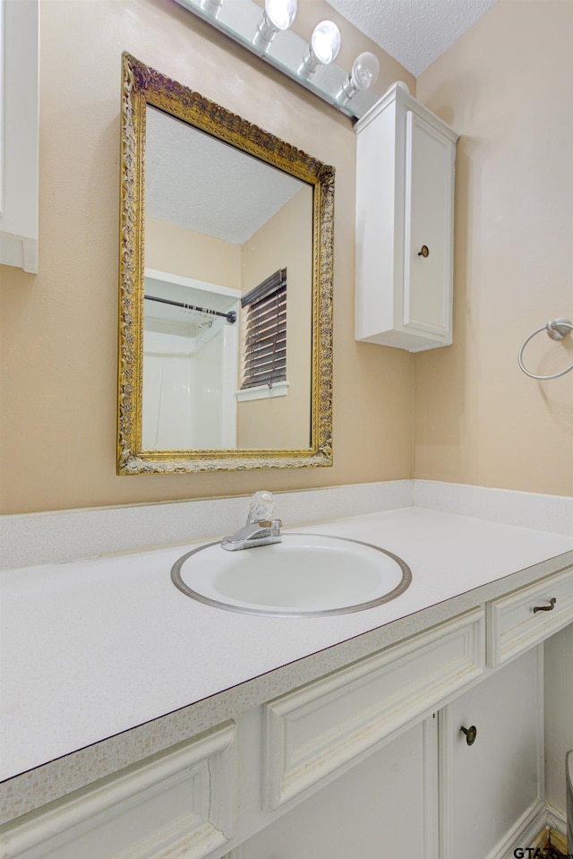 bathroom with vanity and a textured ceiling