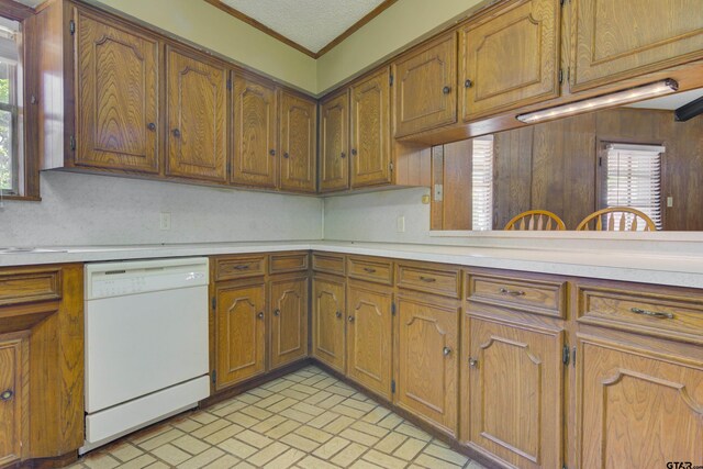 kitchen featuring ornamental molding, a textured ceiling, and white dishwasher