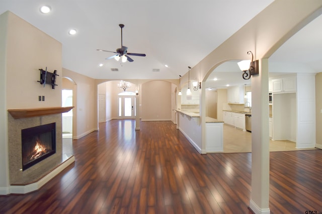 413 Maggie Cir, Flint, TX 75762 - unfurnished living room with arched walkways, a ceiling fan, dark wood-style floors, recessed lighting, and a fireplace