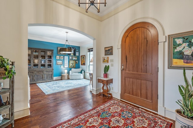 foyer entrance featuring crown molding and dark hardwood / wood-style floors