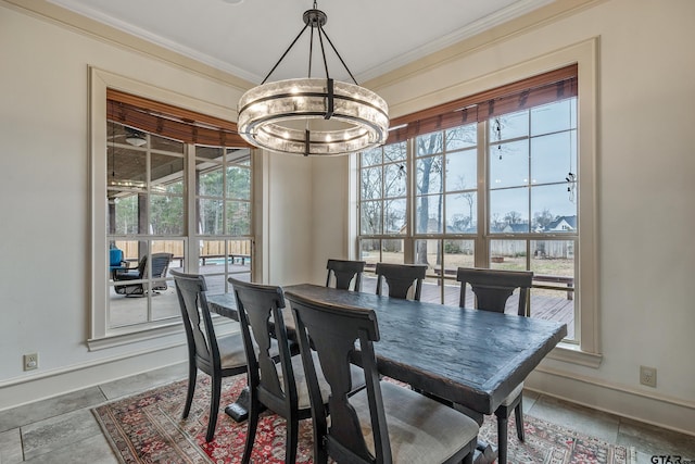 dining room with crown molding and an inviting chandelier