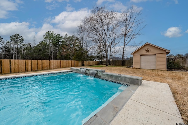 view of pool featuring a garage and an outdoor structure