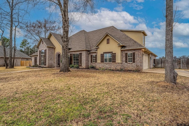 view of front of property featuring a garage and a front lawn