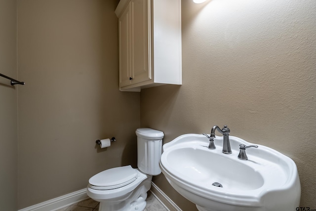 12105 Jazmin Cir, Flint, TX 75762 - bathroom with a sink, baseboards, toilet, and tile patterned flooring