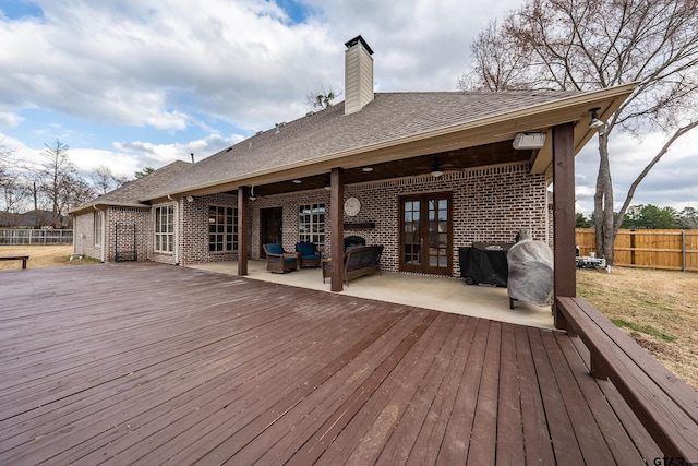 deck featuring outdoor lounge area, a patio, and ceiling fan