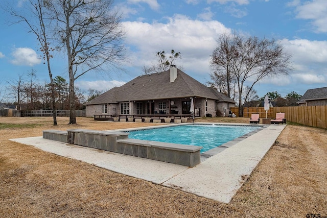 view of swimming pool with a yard and a patio