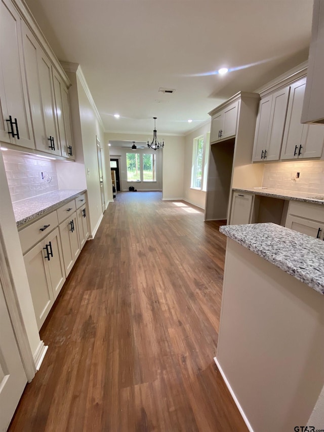 1316 Claude St, Tyler, TX 75702 - kitchen with dark wood-type flooring, backsplash, baseboards, ornamental molding, and recessed lighting
