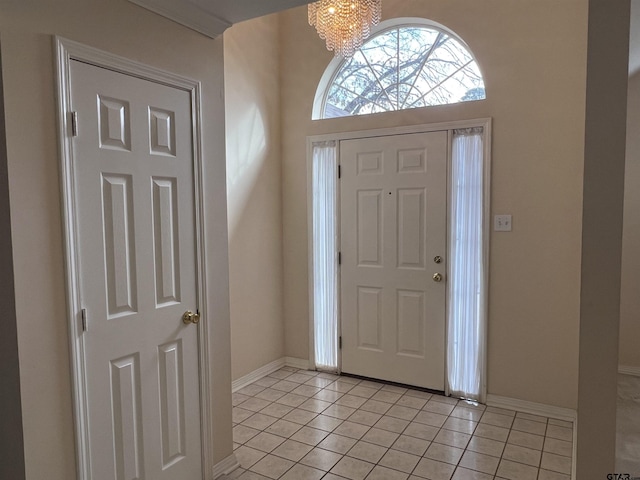 foyer entrance featuring an inviting chandelier and light tile patterned floors