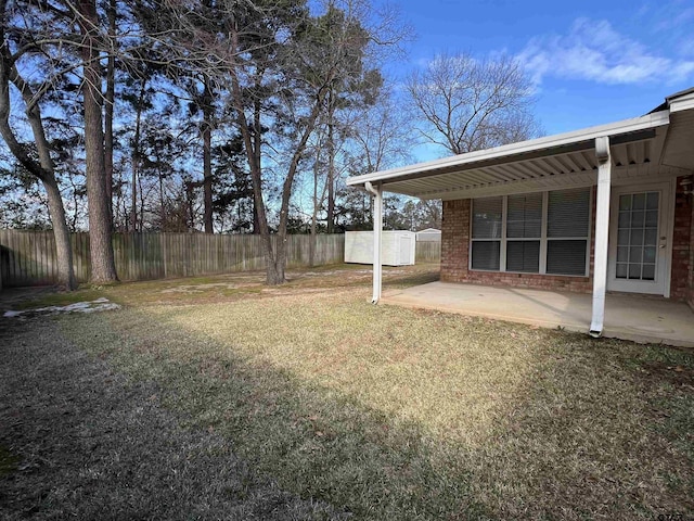 view of yard featuring a storage shed and a patio