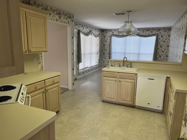 kitchen with pendant lighting, sink, white appliances, and light brown cabinetry