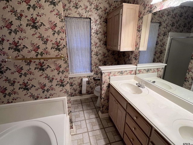 bathroom with toilet, tile patterned floors, and vanity