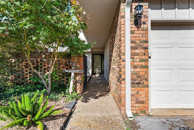 view of exterior entry with a garage