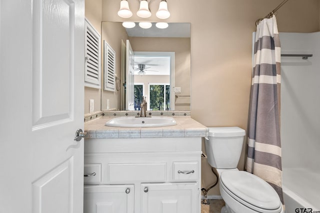 bathroom with walk in shower, ceiling fan, vanity, and toilet