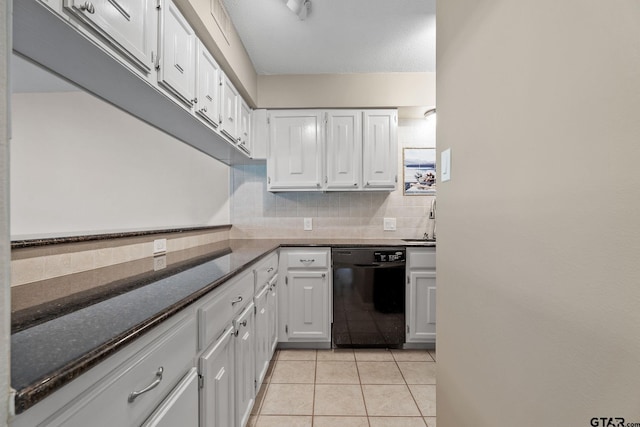 kitchen with black dishwasher, white cabinetry, dark stone counters, and backsplash