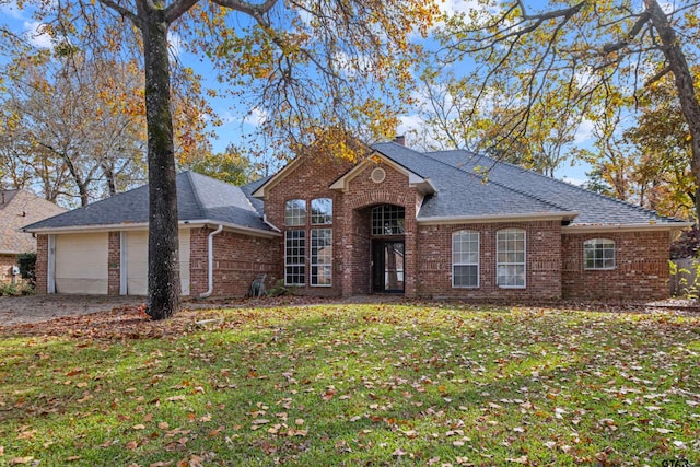 front of property with a garage and a front yard