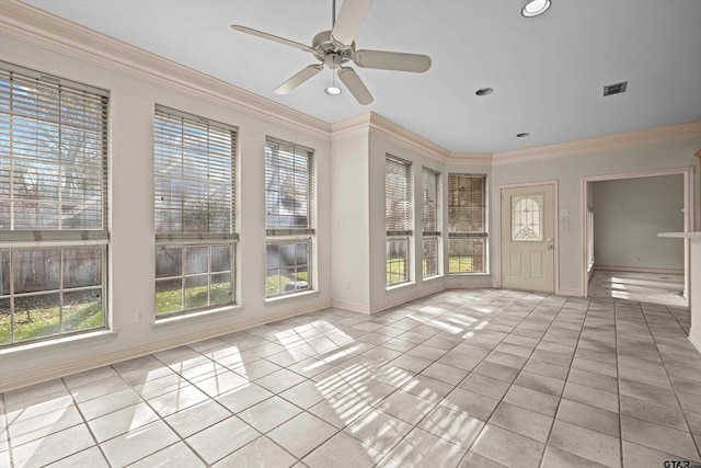 unfurnished sunroom with ceiling fan and a healthy amount of sunlight