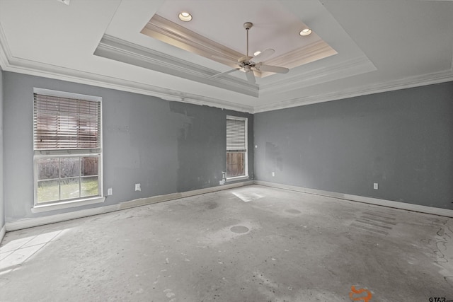 spare room featuring a raised ceiling, ceiling fan, and ornamental molding