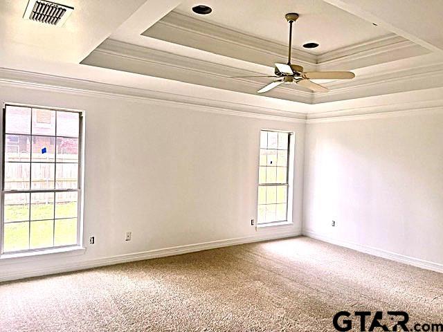 tiled empty room featuring ceiling fan and ornamental molding