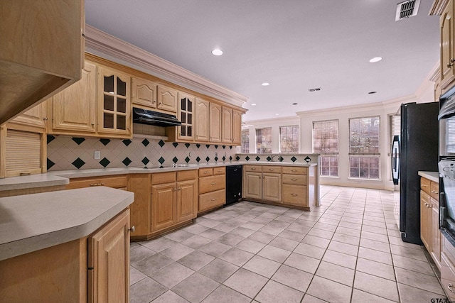 kitchen with cooktop, tasteful backsplash, black fridge, and ornamental molding