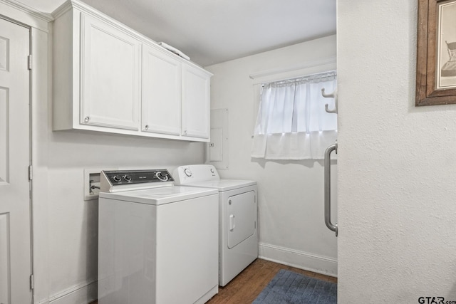 washroom featuring dark wood-type flooring, cabinets, and washer and dryer