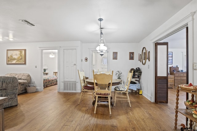 dining space featuring wood-type flooring