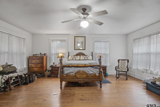 bedroom with wood-type flooring and ceiling fan