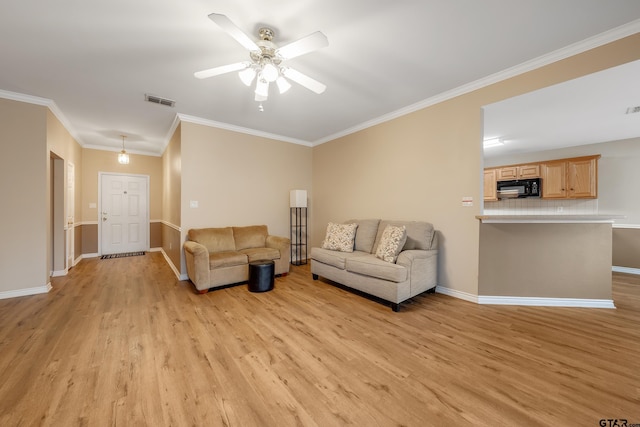 living room featuring crown molding, ceiling fan, and light wood-type flooring