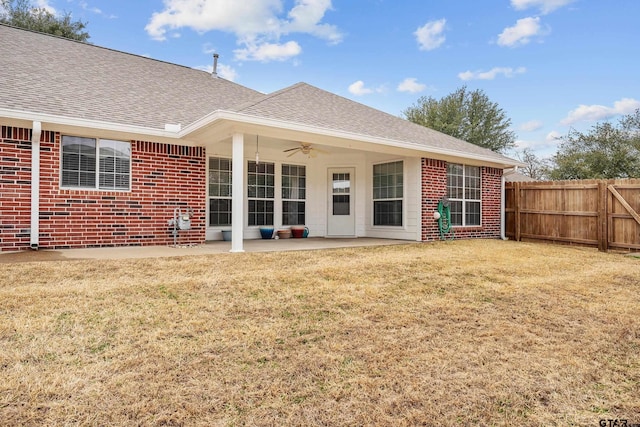 back of property featuring a yard, ceiling fan, and a patio area