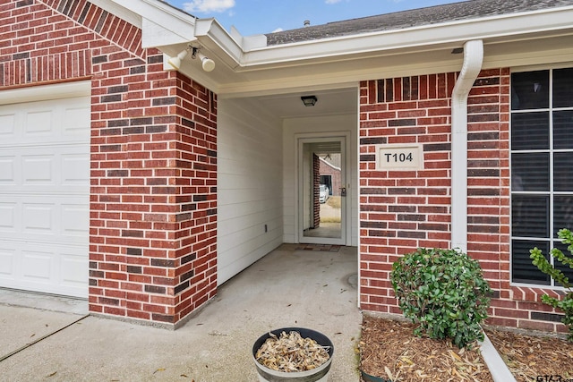 view of exterior entry with a garage