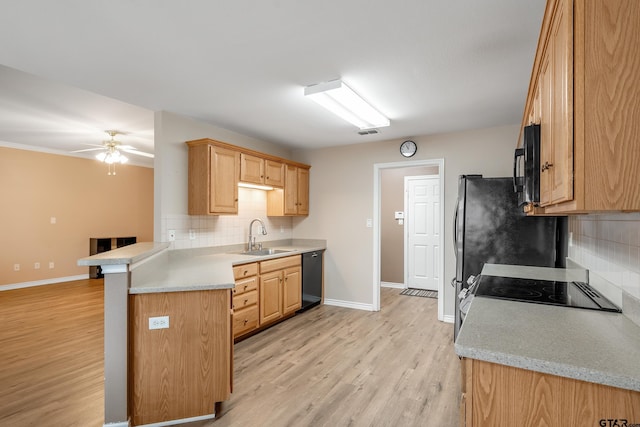 kitchen featuring sink, ceiling fan, light hardwood / wood-style floors, black appliances, and kitchen peninsula