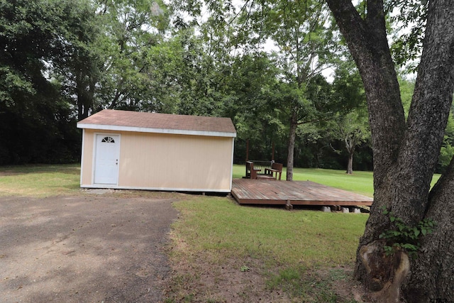 view of yard with a wooden deck and a storage unit