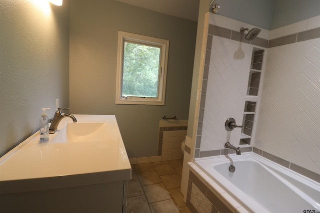 bathroom featuring vanity, tiled shower / bath combo, and tile patterned floors