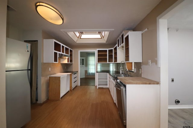 kitchen featuring white cabinetry, sink, light hardwood / wood-style flooring, and appliances with stainless steel finishes