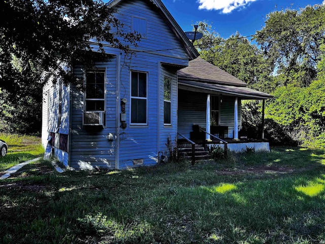 view of property exterior with a yard and covered porch