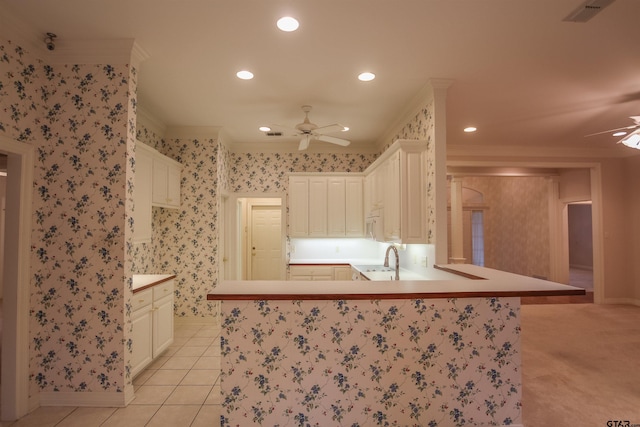 704 Paloma St, Tyler, TX 75703 - kitchen with a ceiling fan, a peninsula, recessed lighting, ornamental molding, and wallpapered walls