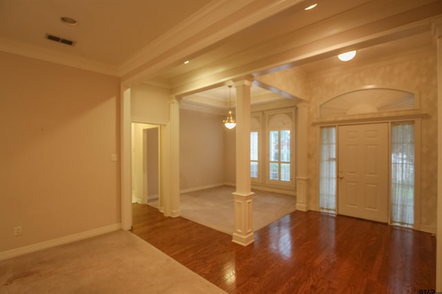704 Paloma St, Tyler, TX 75703 - foyer with decorative columns, ornamental molding, wood finished floors, and a chandelier