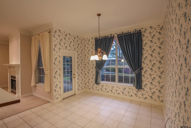 704 Paloma St, Tyler, TX 75703 - unfurnished dining area with crown molding, a chandelier, wallpapered walls, a fireplace, and tile patterned floors