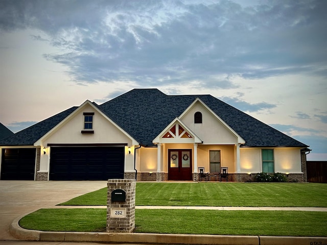 craftsman house featuring french doors, a front lawn, and a garage