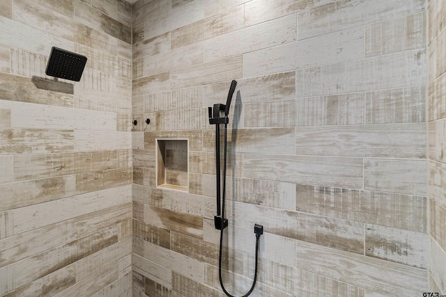 bathroom with tiled shower