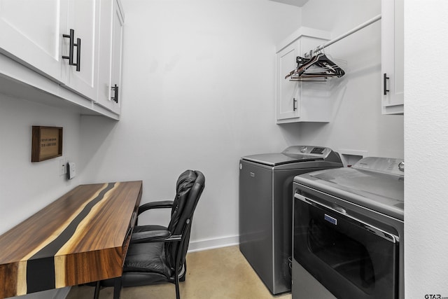 washroom with cabinets and washing machine and clothes dryer