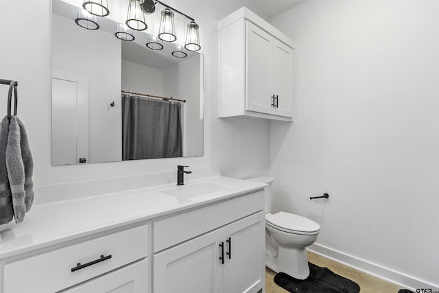 bathroom with vanity, a shower with shower curtain, and toilet