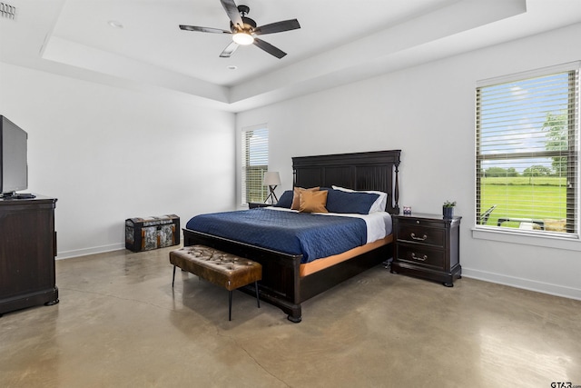 bedroom featuring ceiling fan and a tray ceiling