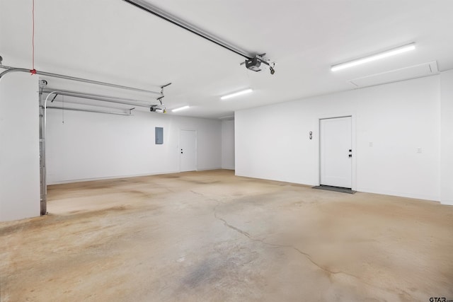 garage featuring electric panel and a garage door opener