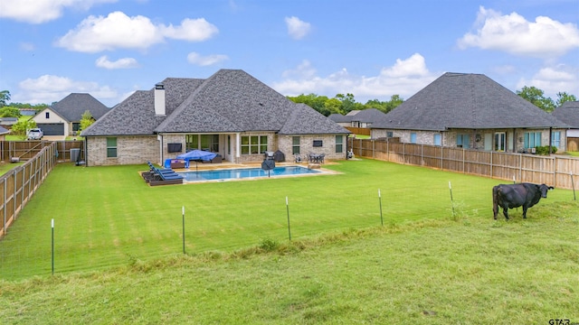 exterior space featuring a fenced in pool and a yard