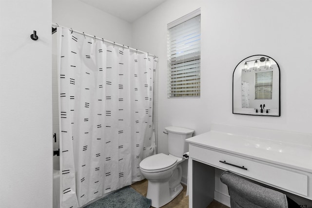 full bathroom featuring shower / bath combination with curtain, vanity, and toilet