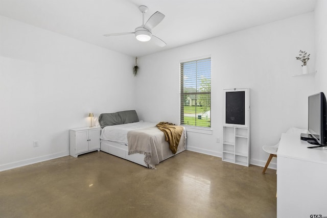 bedroom featuring ceiling fan and concrete floors