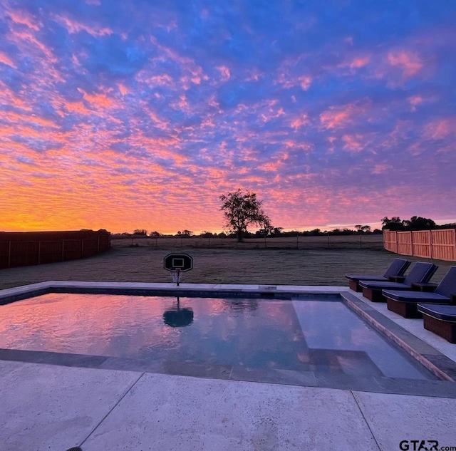 view of pool at dusk