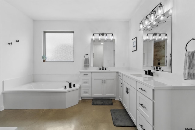 bathroom featuring vanity, concrete flooring, and a tub