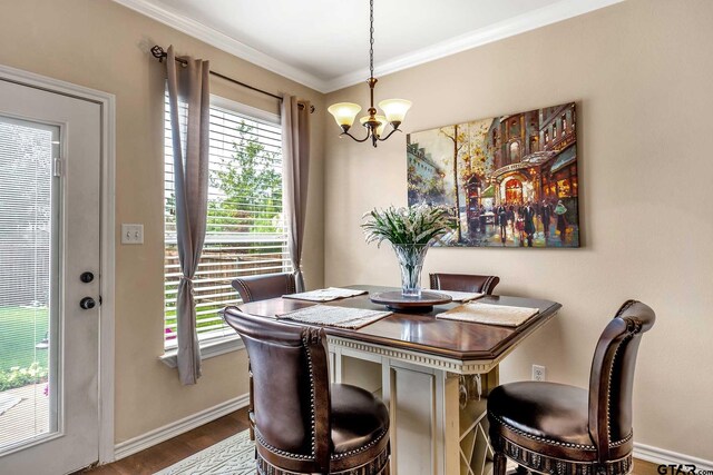 dining room featuring a notable chandelier, wood-type flooring, and ornamental molding